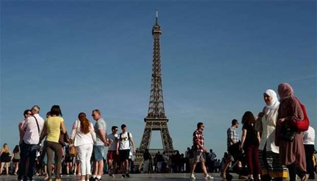 People walk on the Trocadero Esplanade near the Eiffel Tower in Paris. File picture