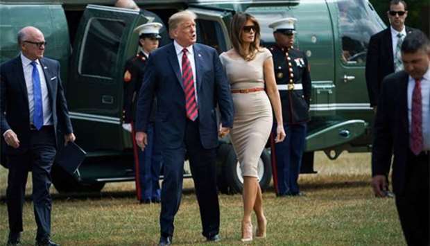 US President Donald Trump and First Lady Melania Trump walk with US ambassador Woody Johnson as they arrive at the US ambassador's residence, Winfield House, in London on Thursday.