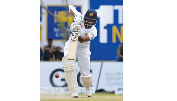 Sri Lankan batsman Dimuth Karunaratne plays a straight drive during the day one of first Test against South Africa in Galle, Sri Lanka yesterday. (AFP)