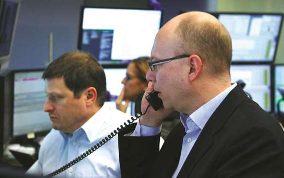 Traders at the Frankfurt Stock Exchange. The DAX 30 gained 0.6% to 12,492.97 points yesterday.