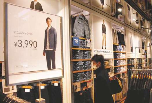 A man looks around clothes at a Fast Retailingu2019s Uniqlo store in Tokyo. For the quarter ended May, Fast Retailingu2019s operating profit was u00a568.4bn ($609.41mn), up 37% from a year ago.