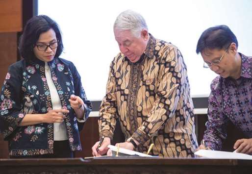 Indonesiau2019s Finance Minister Sri Mulyani (left) looks on as CEO and vice chairman of Freeport-McMoRan Copper and Gold, Richard Adkerson (centre), and director of state-owned mining firm Inalum, Budi Gunadi Sadikin, take part in a signing ceremony in Jakarta yesterday.