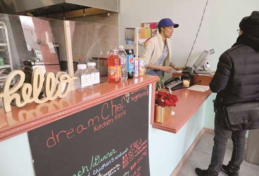 IN BUSINESS: Chef Nichelle Benford owner of Dream Chef Kitchen in Chicagou2019s Lawndale neighbourhood, rings up customers orders during the lunch time rush at the restaurant.