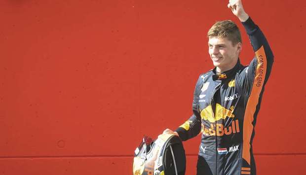 Red Bullu2019s Max Verstappen crosses the finish line to take the chequered flag and win the Austrian Grand Prix yesterday. At right, he celebrates on the podium.