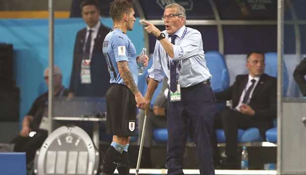 Uruguay coach Oscar Tabarez gives instructions to midfielder Lucas Torreira. (Reuters)