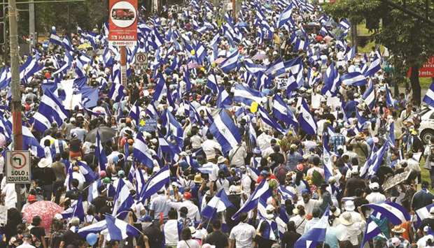People attend the u2018Marcha de las Floresu2019 in Managua to honour the children killed during earlier protests.