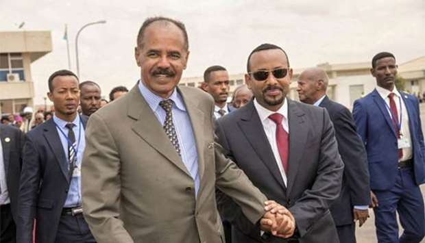 Eritrean President Isaias Afwerki and Ethiopia's Prime Minister Abiy Ahmed walk together at Asmara International Airport on July 9.
