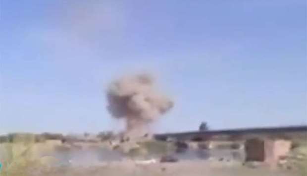 An image grab from a video posted on Twitter shows smoke rising after an air strike in Deir Ezzor