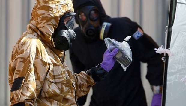 Forensic investigators, wearing protective suits, emerge from the rear of John Baker House, after it was confirmed that two people had been poisoned with the nerve-agent Novichok, in Amesbury, Britain on July 6, 2018.