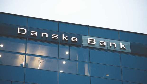 A logo is displayed above offices at the headquarters of Danske Bank in Vilnius, Lithuania. There are so far no charges or convictions, but analysts are already guessing how big a fine Danske Bank might have to pay following allegations it became a major hub for money laundering in Europe.