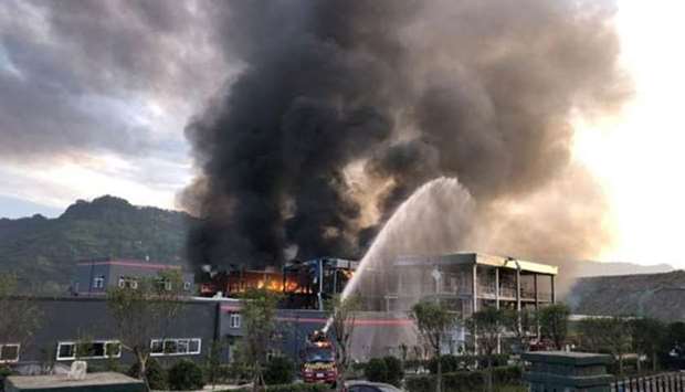 Rescue workers try to put out a fire after an explosion at a chemical plant inside an industrial park in Yibin, Sichuan province, on Friday.