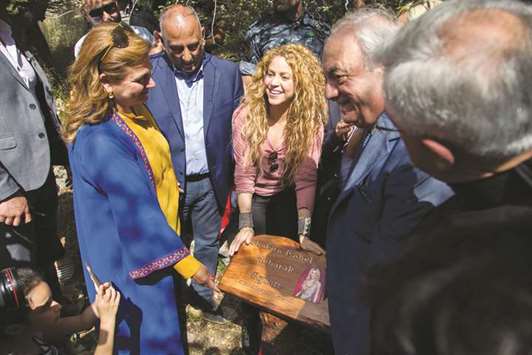 A handout picture provided by the Honorary Consulate of Lebanon in Barranquilla, Colombia, yesterday shows Colombian singer Shakira holding a commemorative plaque bearing her name during her visit to the northern Lebanese mountain village of Tannourine where her paternal grandmother was born.