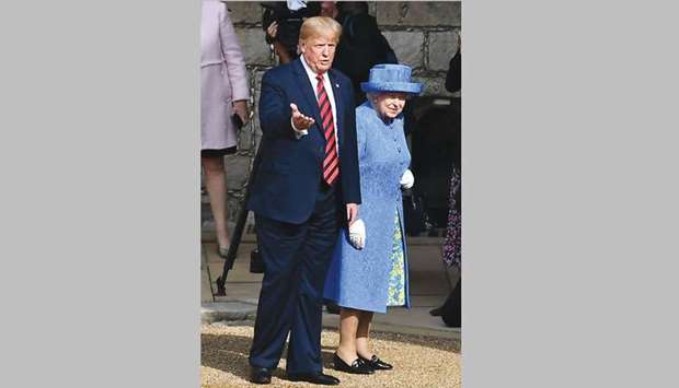 Queen Elizabeth and US President Donald Trump walk through the Quadrangle toward an entrance at Windsor Castle, Windsor, yesterday.