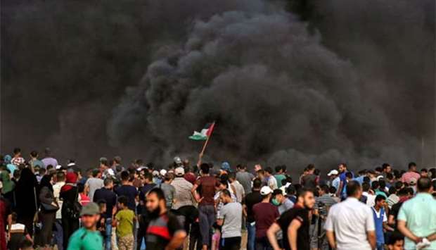 Smoke from a tyre fire rises as Palestinians protest near the border with Israel east of Gaza City on Friday.