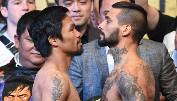 Philippines' Manny Pacquiao (left) and Argentina's Lucas Matthysse pose for pictures after the weigh-in event in Kuala Lumpur on Sunday.