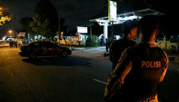 Indonesian police guard is seen near the scene of a shooting in Sleman, Yogyakarta, Indonesia