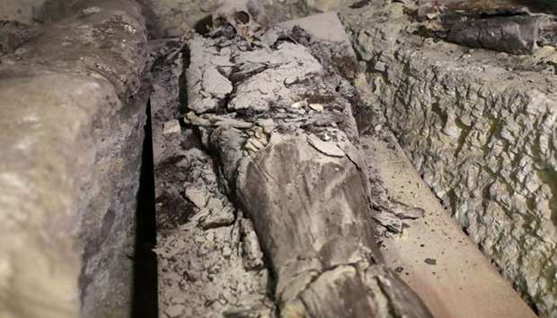 A mummy is seen inside the newly discovered burial site near Egypt's Saqqara necropolis, in Giza Egypt.