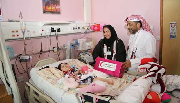 QRCS officials with a child patient
