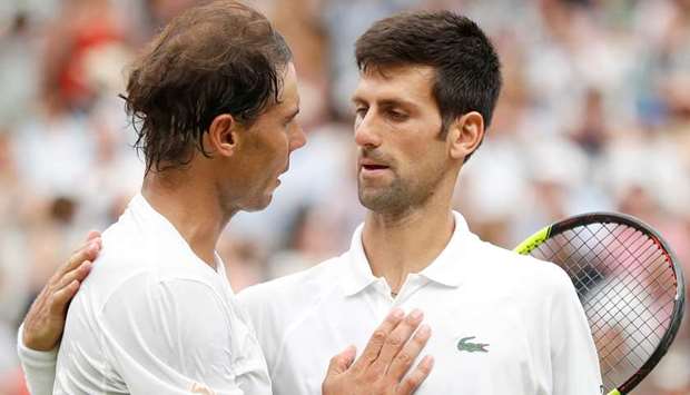 Serbiau2019s Novak Djokovic (R) with Spainu2019s Rafael Nadal after their Wimbledon semi-final yesterday.