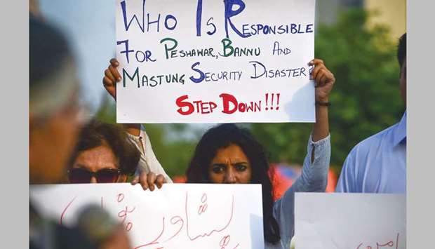 An activist holds a placard during a protest in Islamabad against the bombing attacks.