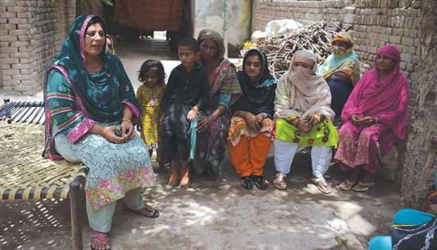 In this picture taken on July 7, Bismillah Noor (left), a Pakistani social worker and member of district council, tries to convince local village women to use their vote in the upcoming general election in Mohri Pur village.