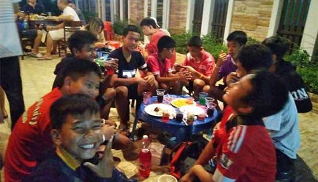 This photo taken around mid-April 2018 shows Chanin Vibulrungruang, 11, seen at left in dark shirt, one of the members of Wild Boars rescued from the flooded cave on July 10. He is shown together with teammates during a party in Mae Sai, Chiang Rai province.