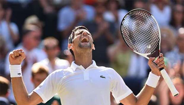 Serbia's Novak Djokovic celebrates after beating South Africa's Kevin Anderson 6-2, 6-2, 7-6 in their men's singles final at the Wimbledon on Sunday.