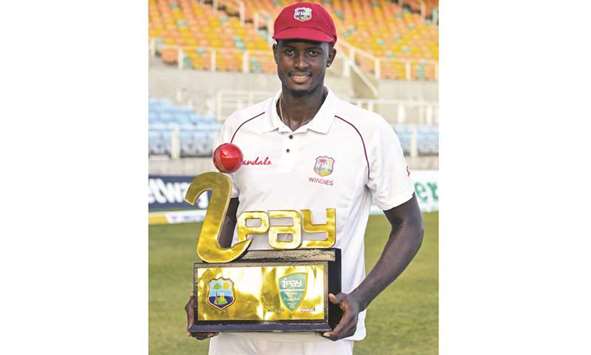 Jason Holder of West Indies holds the winners trophy after winning the second Test against Bangladesh at Sabina Park, Kingston, Jamaica, on Saturday. (AFP)