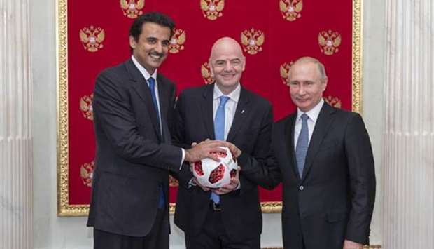 His Highness the Amir Sheikh Tamim bin Hamad al-Thani receiving the mantle of hosting the 2022 World Cup in Qatar from Russian President Vladimir Putin in the presence of FIFA president Gianni Infantino in Moscow on Sunday.