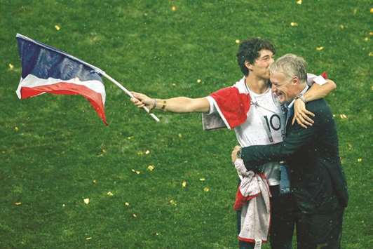 Franceu2019s coach Didier Deschamps celebrates with his son Dylan after the World Cup final at the Luzhniki Stadium in Moscow yesterday. (AFP)