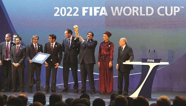 File photo dated December 2, 2010 showing His Highness Sheikh Hamad bin Khalifa al-Thani raising the World Cup trophy as he stands with Her Highness Sheikha Moza bint Nasser and members of the Qatar 2022 bid committee and the then FIFA president Joseph Blatter after Qatar was chosen to host the 2022 World Cup at the FIFA headquarters in Zurich.