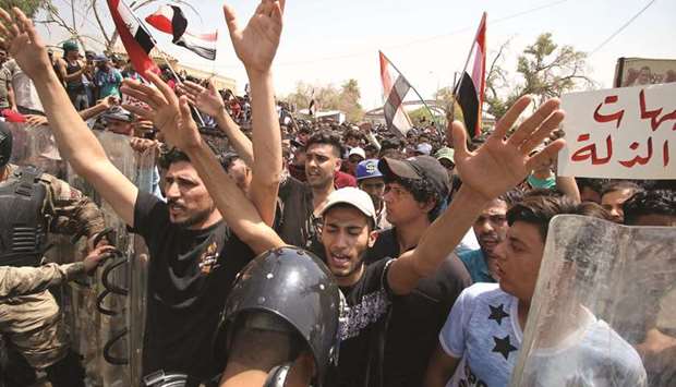 People shout slogans during a protest near the main provincial government building in Basra, yesterday.