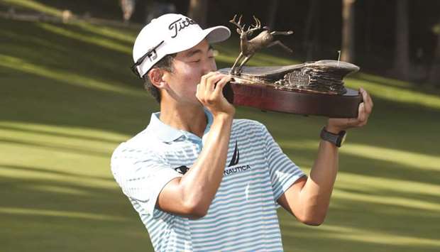 PGA golfer Michael Kim kisses the trophy after winning the John Deere Classic at TPC Deere Run. PICTURE: USA TODAY Sports