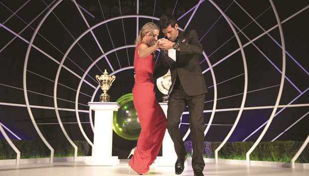 Serbiau2019s Novak Djokovic and Germanyu2019s Angelique Kerber dance on stage at the Wimbledon Championships Dinner at The Guildhall, London. (Reuters)