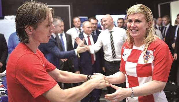 Croatia's President Kolinda Grabar-Kitarovic (right) greets captain Luka Modric.