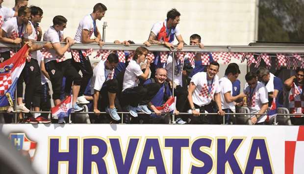 Croatian players parade through the streets of Zagreb on an open-top bus after their return from Moscow yesterday. (AFP)