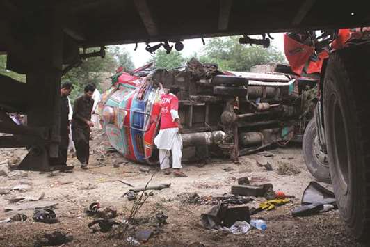 Residents gather around the wreckage of a bus and truck following a collision near Hyderabad.