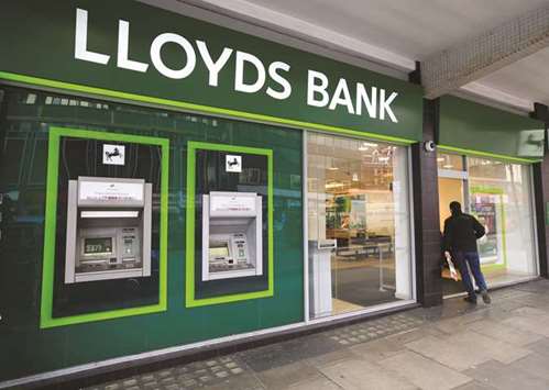 A man enters a Lloyds Bank branch in central London. Lloyds plans to operate three subsidiaries in continental Europe after Britain leaves the EU, according to a source familiar with the matter, in a sign of how Brexit is fragmenting a banking industry long  concentrated in London.