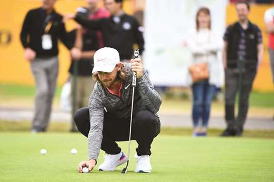 Englandu2019s Tommy Fleetwood sets up a shot on the greens during a practice session at The Open on Monday. (AFP)
