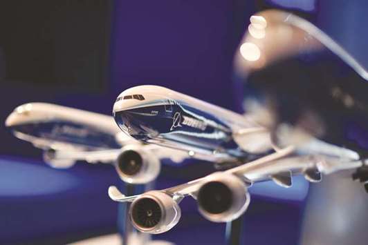 A model of a Boeing 777X is displayed during the Farnborough Airshow. Boeing raised its rolling 20-year industry forecast for passenger and cargo aircraft yesterday, as a steady flow of deals on day two of the air show underscored the industryu2019s resilience to rising global trade tensions.