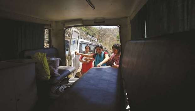 Nepali mother Pabitra Dhungel, centre, getting into an ambulance a day after giving birth, at a health centre in the Ramechhap district, some 100kms east of Kathmandu.