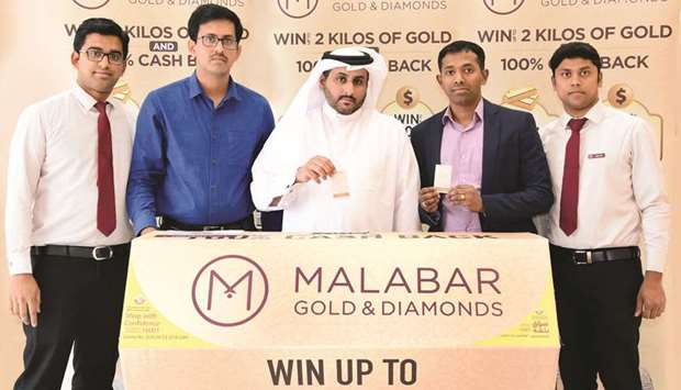 The winners with Malabar Gold & Diamonds representatives and ministry official Roumi al-Naimi.