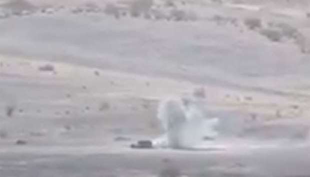 Smoke rises as a vehicle being hit in shelling in Yemen
