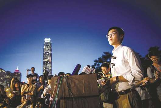 This file photo, Andy Chan, right, leader of the pro-independence Hong Kong National Party and a disqualified candidate of the cityu2019s elections, speaking at a conference at the start of a rally in Hong Kong.