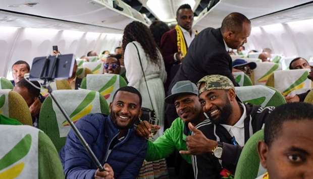 Passengers pose for a selfie picture inside an Ethiopian Airlines flight who departed from the Bole International Airport in Addis Ababa, Ethiopia, to Eritrea's capital Asmara.