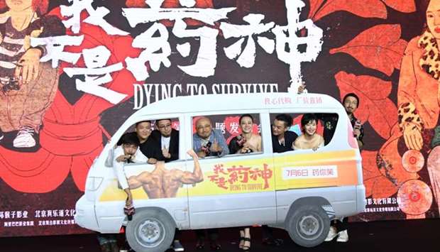 Director Wen Muye poses for a picture with cast members and crew of the movie Dying To Survive at the 21st Shanghai International Film Festival, in Shanghai, China.