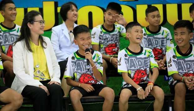 The 12 football players and their coach react as they explain their experience in the cave during their news conference in the northern province of Chiang Rai, Thailand