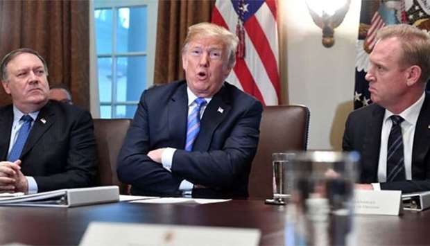 President Donald Trump, with Secretary of State Mike Pompeo (left) and Deputy Secretary of Defense Patrick Shanahan, speaks during a cabinet meeting at the White House in Washington, DC on Wednesday.