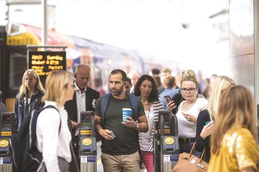 Commuters exit ticket barriers after arriving at London Waterloo railway station in London. Despite motor fuel prices rising to their highest since 2014 in the UK, annual consumer price inflation held in June at 2.4%, the Office for National Statistics (ONS) said yesterday.