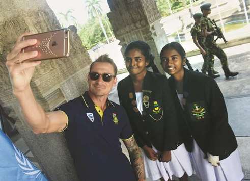 South African pacer Dale Steyn takes a selfie with school girls at a ceremony to mark the 100th birth anniversary of South African anti-apartheid revolutionary and statesman Nelson Mandela in Colombo. (AFP)